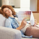 Woman on sofa: Homeowner choosing home improvement from colour range